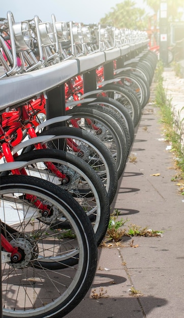 Row of bikes available to sell or rent in Spain on soft sunlight