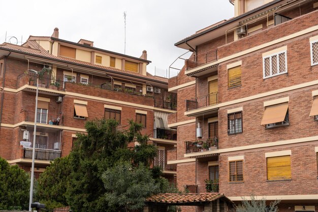 A row of brick buildings with balconies and shutters