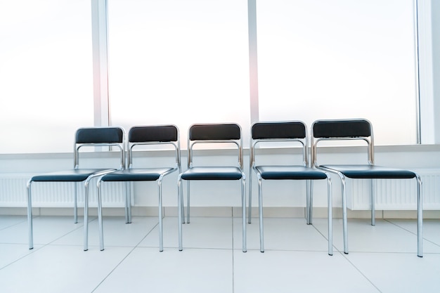 Row of chairs in the office hallway . photo with copy space