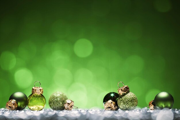 A row of christmas ornaments with green background