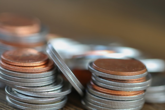 Row of coins on wood background for finance background