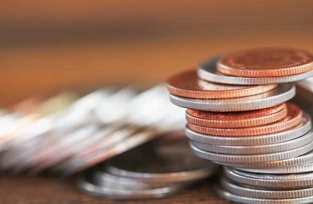 Row of coins on wood background for finance and Saving concept,Investment, Economy, Soft focus