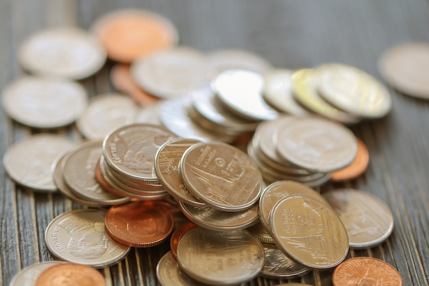 Row of coins on wood background for finance