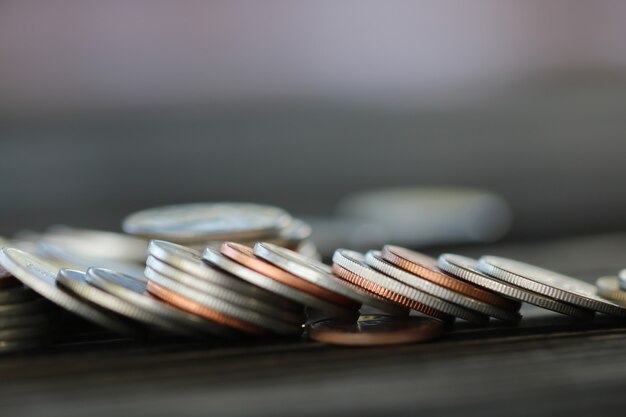 Row of coins on wood background for finance