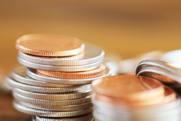 Row of coins on wood background