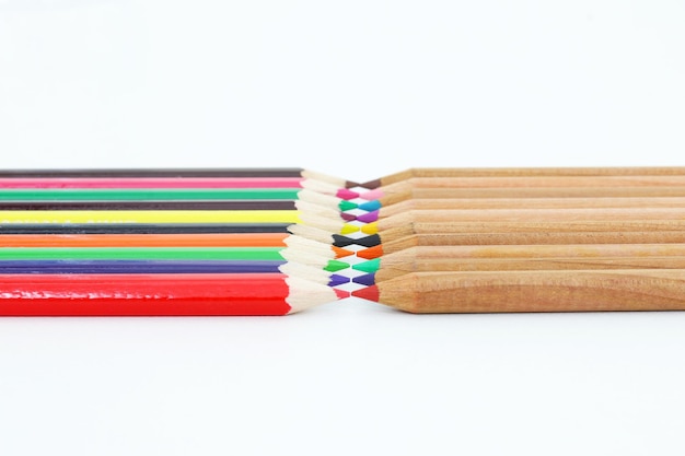 A row of colored pencils are stacked together, one of which is red, one of which is red.