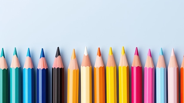 A row of colored pencils with a blue background.