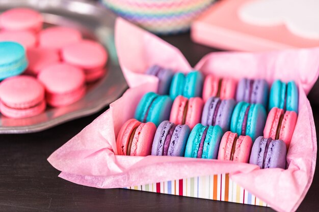 Row of colorful french macaroons in the box.