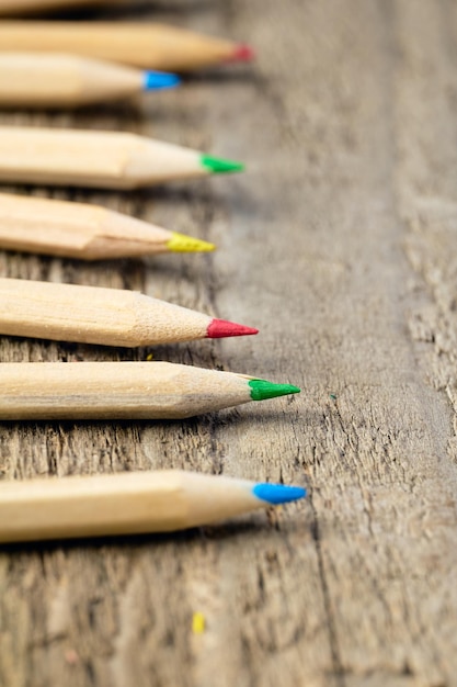 Row of colorful pencils on a table vertical image