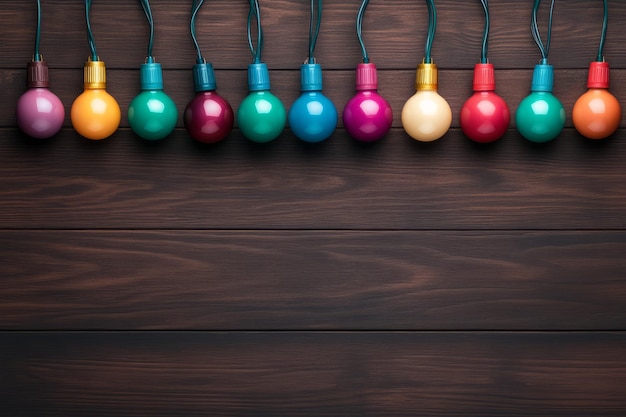 Photo row of colorful string lights hanging against a dark wooden background