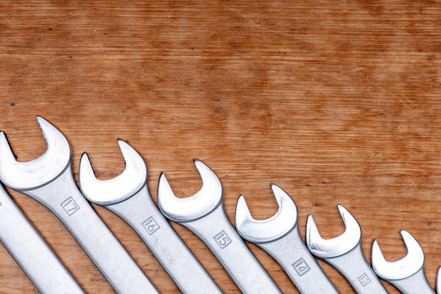 Row of combination keys of different sizes on wooden backing