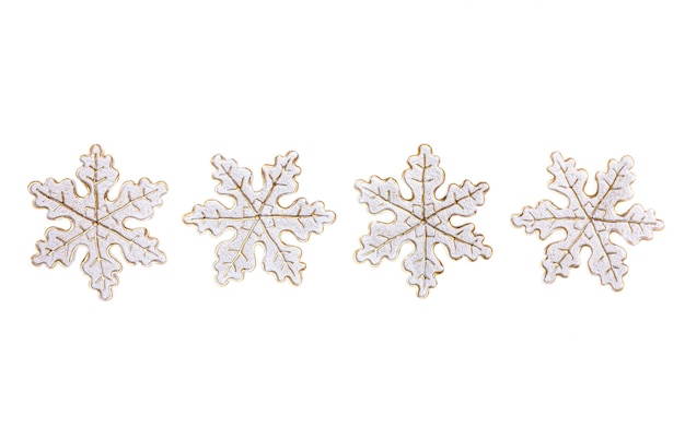 Row of decorative snowflakes in center of on white Christmas minimal image with copy space