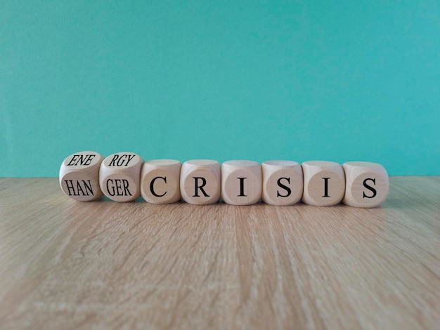 A row of dice with the word crisis on it Energy or hunger crisis symbol