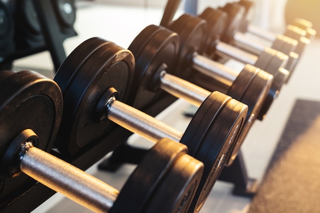 Row of dumbbells set of equipment for weightlifting in gym