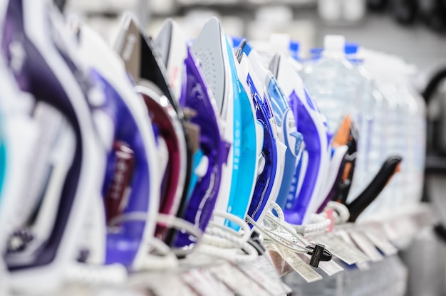 Row of electric irons in retail store