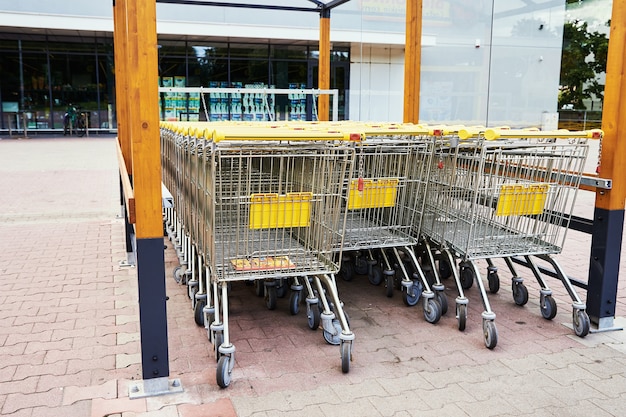 Row of empty shopping cart near a shop, close up