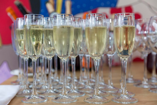 Row of glasses with champagne on the festive table Celebrations and holidays Front view