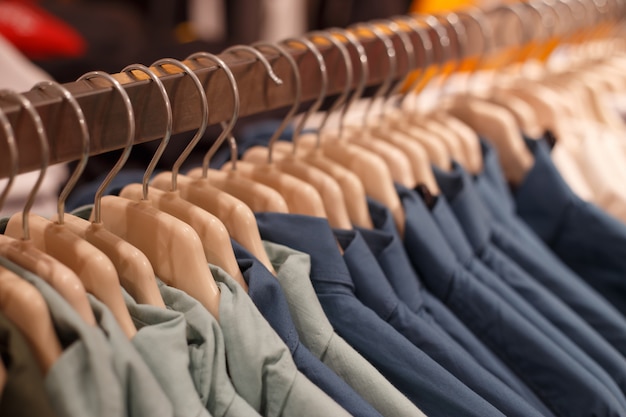 Row of hangers with shirts in a store