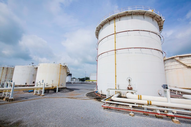 The row of large white tanks for petrol steel long pipeline