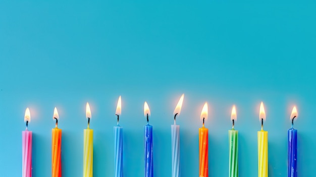 Photo a row of lit candles against a solid blue background