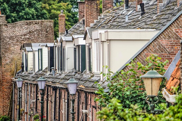 Photo row of old houses with dormers in an old dutch town center