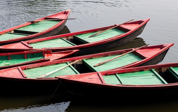 A row of parked wooden boats on the river close up