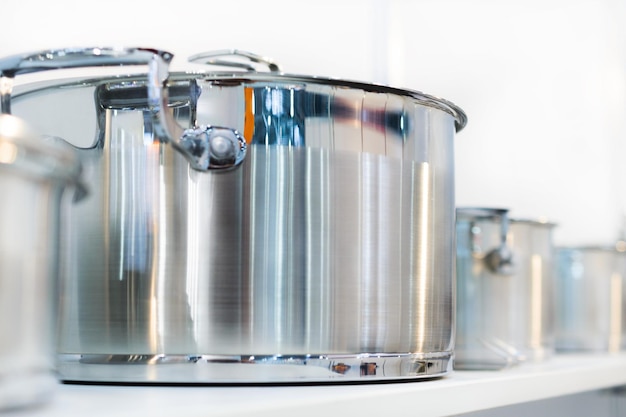 Row of stainless pot on a shelf