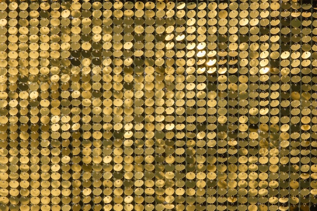 Rows of blinking golden yellow brass metal plaques sway in wind and shines in sun and create unique pattern of movement round reflective particles texture glitter under waves of wind Spangle Glitter