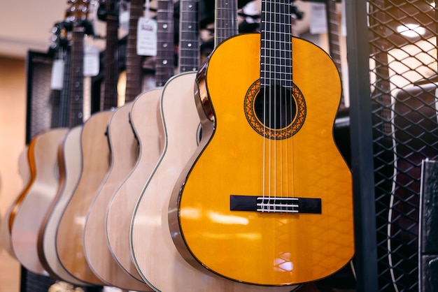 Rows of classical guitars with racks and variousin music store