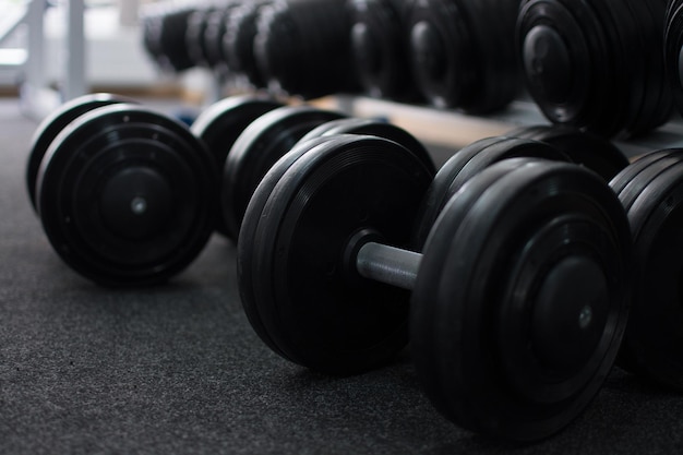 Rows of dumbbells in the gym in the dark colors