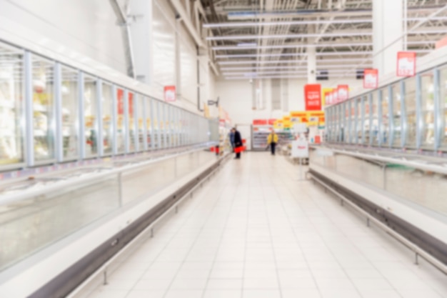 Rows of frozen food display cases in a large supermarket.