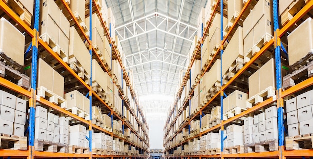 Rows of shelves with boxes in modern warehouse