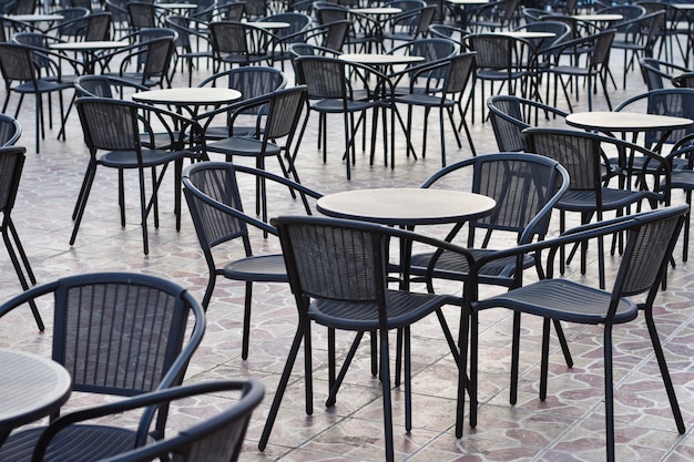 Rows of tables with chairs outside in the hotel