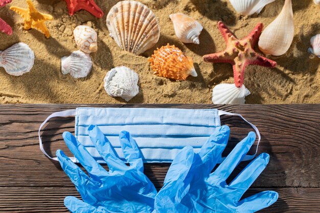 Photo rubber gloves protective mask sea beach pandemic period and the prevalence of the contagious disease covid19