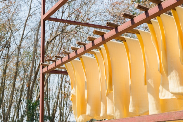 Photo the rubber sheet are hanged on hanger. rubber production,baking process.