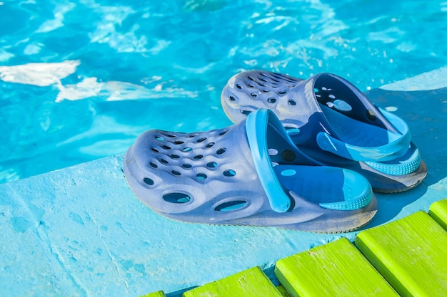 Rubber shoes flip flops near the pool