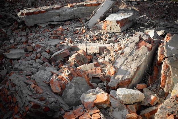 A ruined building with fragments of red bricks and reinforced concrete floors