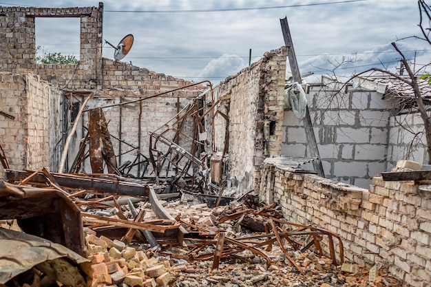 Ruined house. Ruins of a residential building. Brick walls. War in Ukraine.