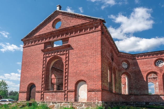 A ruined red brick church. The Catholic Church after a long destruction.