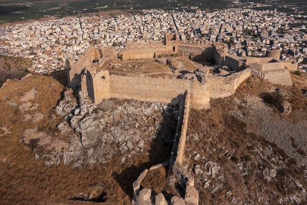 Ruins of ancient Greek fortress Larisa with stone walls and towers over modern Greek city of Argos