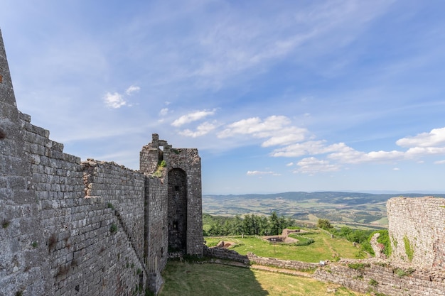 Ruins and remains of the base of Radicofani fortress wall Tuscany Italy