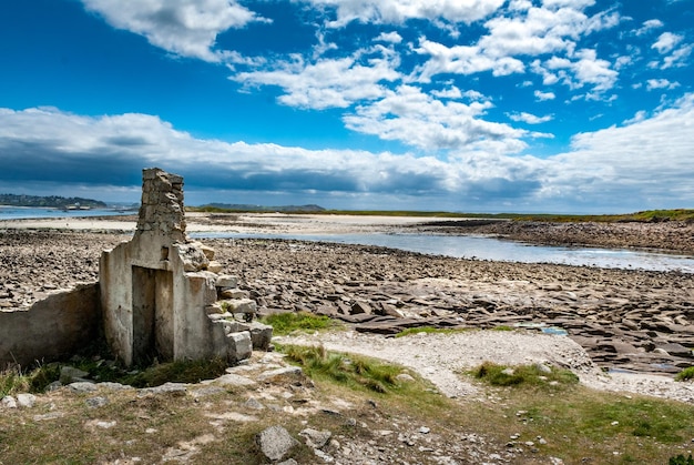 Ruins at the seaside at low tide on the rocky coast of Ile Grande in the north of Brittany