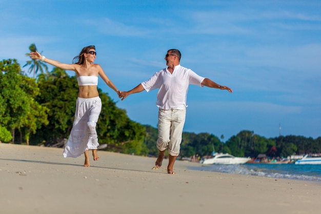 Running couple on a tropical beach