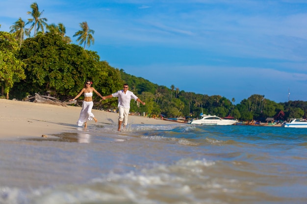 Running couple on a tropical beach