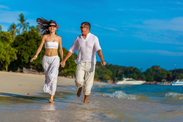 Running couple on a tropical beach