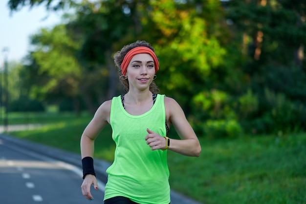 Running Woman on racetrack during training session Female runner practicing on athletics race track