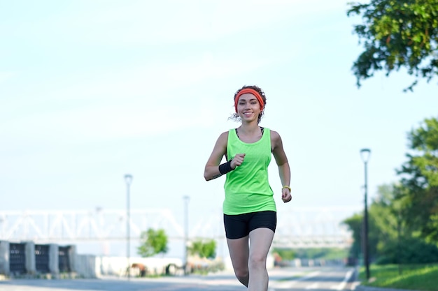 Running woman on the waterfront Morning jogging The athlete trains