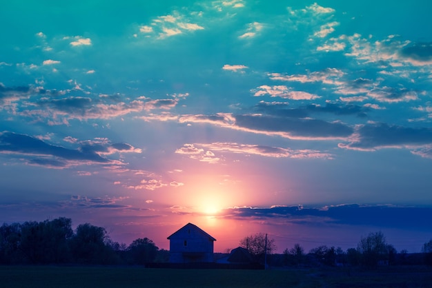 Rural landscape in the evening at sunset Silhouette of the village against a beautiful evening sky