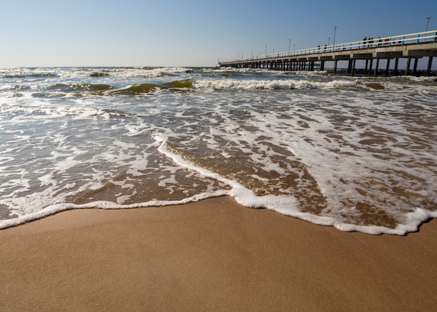 Rushing wave on a sunny day on the sandy beach of the Baltic Sea in Palanga Lithuania