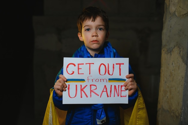 Russia's war against Ukraine in 2022 A sad boy is hiding in a bomb shelter from Russian missiles Stop the war